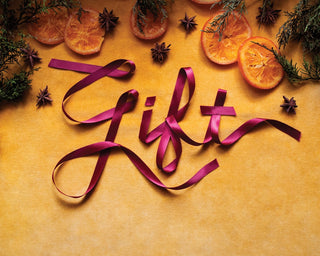 A picture of some fruit and ribbon on a table